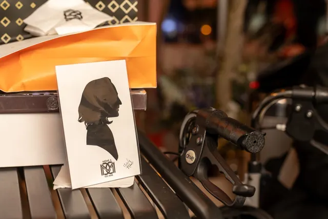 Hand-cut silhouette mounted on a card bearing the party's monogram, a keepsake of Mémé's 100th birthday